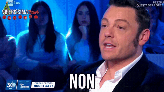 a man in a suit and white shirt says non
