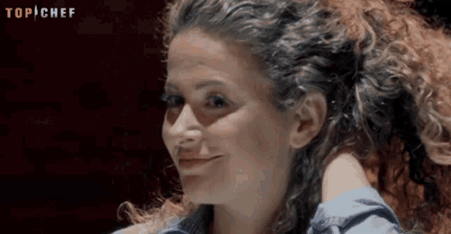 a close up of a woman 's face with the words top chef behind her