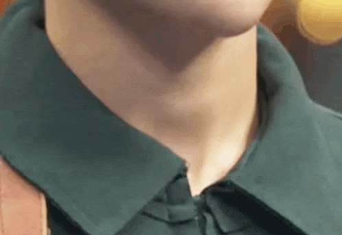 a close up of a person 's neck and collar with a backpack .