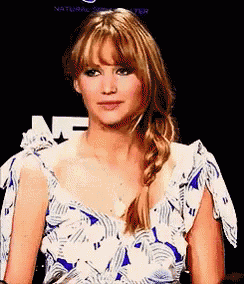 a woman wearing a blue and white floral dress