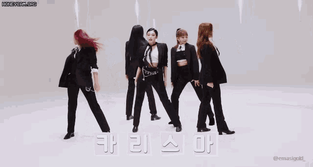 a group of women are dancing in front of a sign that says ' a ' on it