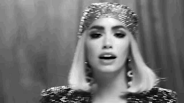 a black and white photo of a woman wearing a headband