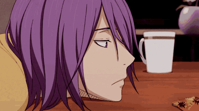 a person with purple hair is laying on a wooden table