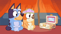 a couple of cartoon dogs sitting next to each other in front of a jewelry box