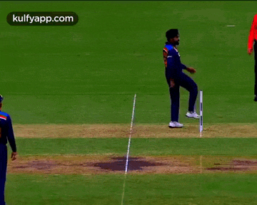 a cricket game is being played on a field with the website kulfyapp.com in the corner