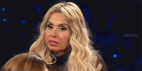 a woman with blonde hair is looking at another woman