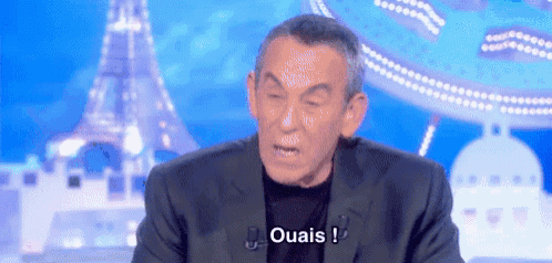 a man in a suit says ouais in front of the eiffel tower .