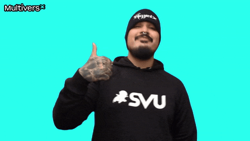 a man giving a thumbs up wearing a svu sweatshirt