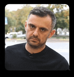 a man with a beard is wearing a black shirt and looking at the camera