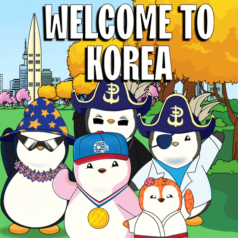 a group of penguins are standing in front of a sign that says " welcome to korea "