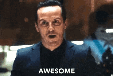 a man in a suit says awesome in front of a blurred background
