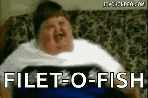 a fat man is sitting on a couch with his mouth open and the words filet-o-fish written on the screen .