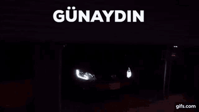 a red car is parked in a garage under a sign that says " günaydin "