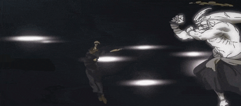 a man is standing in a dark room holding a gun while another man stands behind him .