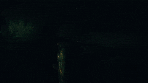 a person is standing in the dark with a glowing face .