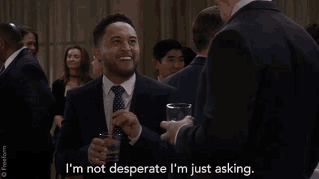 a man in a suit and tie says i 'm not desperate