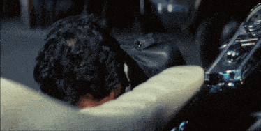 a man laying on a couch with his head resting on the cushion