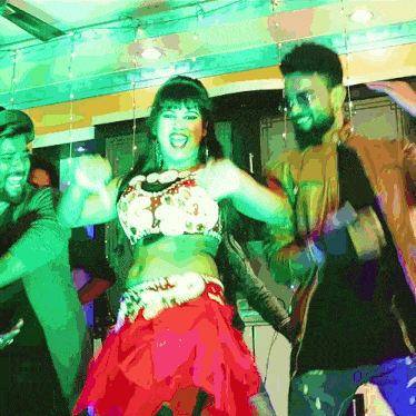 a woman in a red skirt is dancing with a man