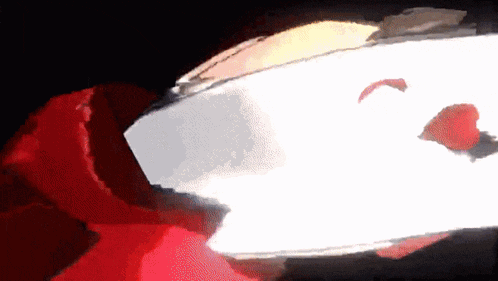 a close up of a person 's face with a red and white background