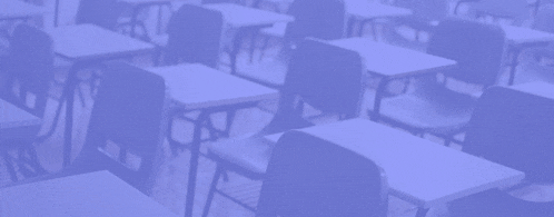 r / igcse is displayed in front of rows of classroom desks