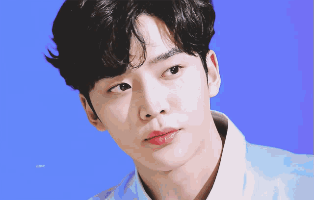 a close up of a person 's face with a blue background and the word bmw visible