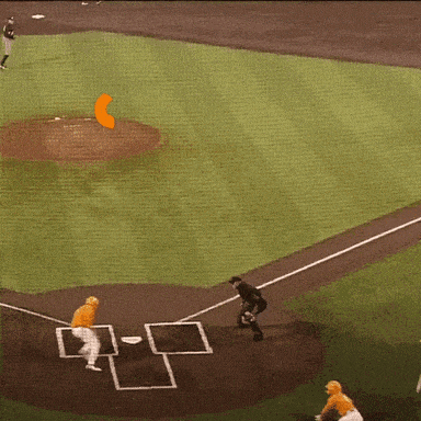 a baseball game is being played on a field with an orange circle in the middle