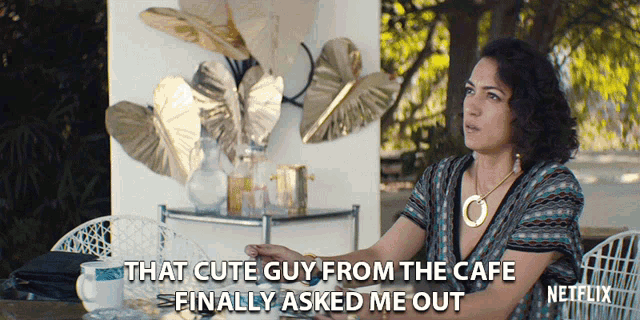 a woman sits at a table with a caption that says that cute guy from the cafe finally asked me out netflix