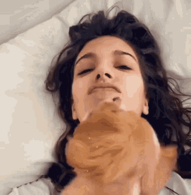 a woman is laying in bed with her eyes closed
