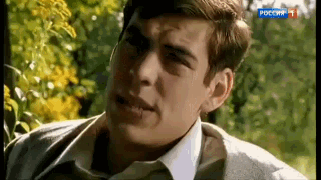 a close up of a man 's face with the number 1 on the bottom right corner
