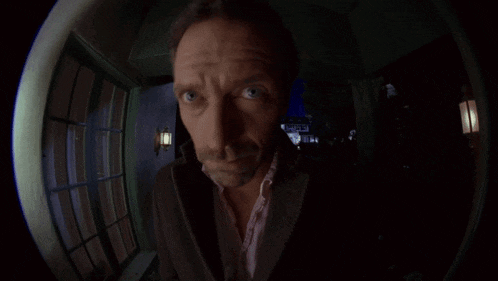 a man looking through a fisheye lens with a sign in the background that says ' motel '