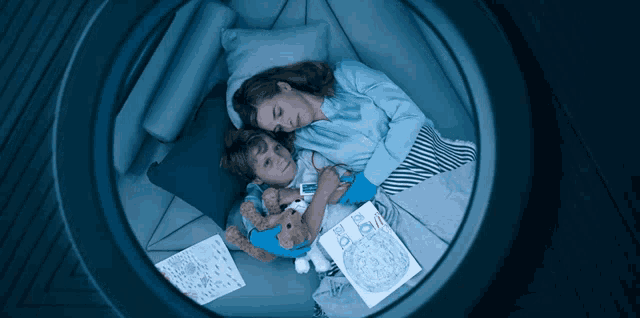 a woman and child are laying in a bed with a book that says " the moon "