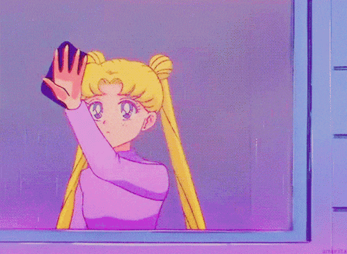 a girl in a pink shirt is looking at her reflection in the mirror