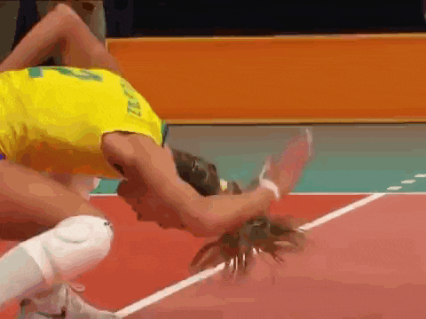 a woman in a yellow shirt with the number 22 on it is playing volleyball
