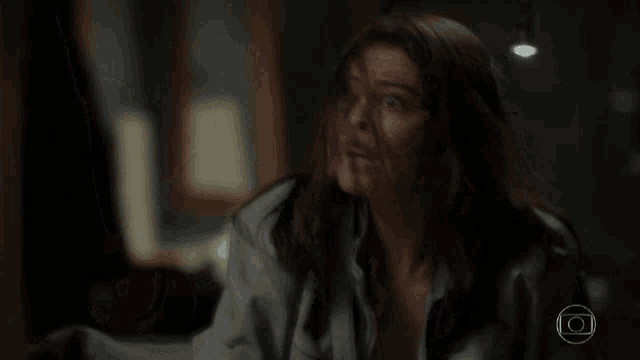 a woman with blood on her face is laying on the floor in a room .