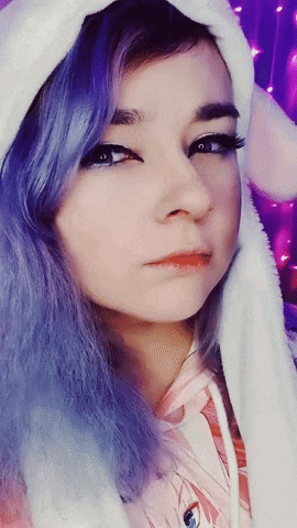 a girl with purple hair is wearing a white bunny hood