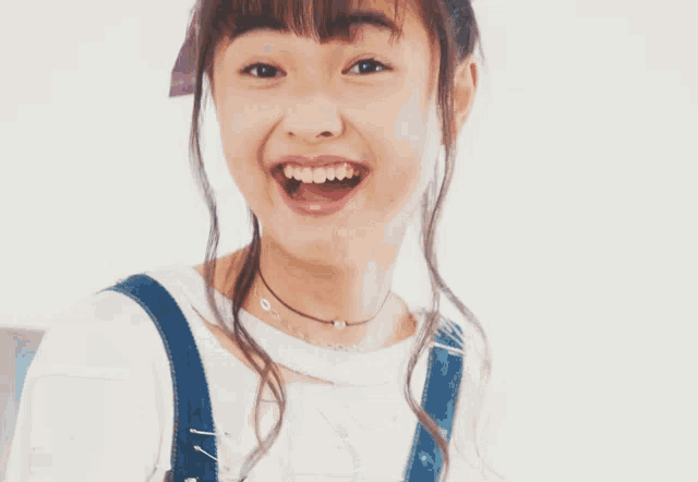 a girl with a plaid headband on her head smiles