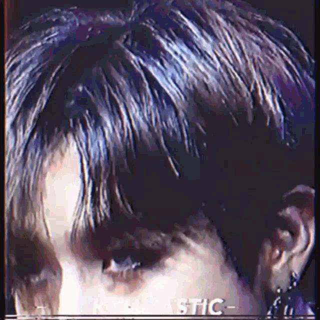 a close up of a person 's face with a glitch effect and the word plastic on the bottom right