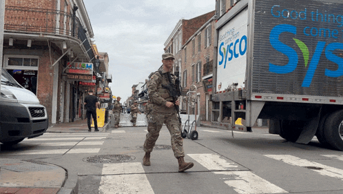 a sysco truck is driving down a busy street