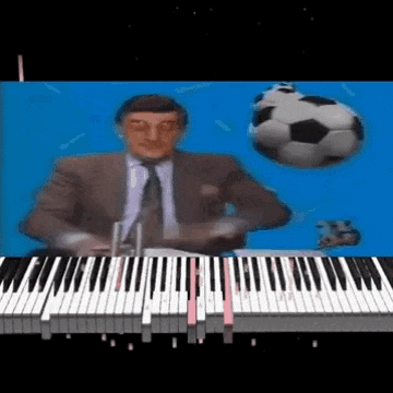 a man in a suit and tie is playing a piano with a soccer ball flying in the background .
