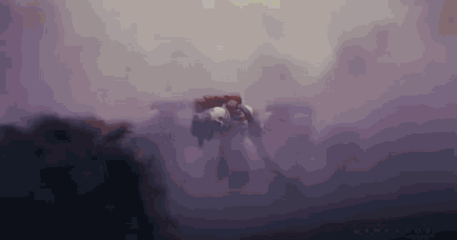 a group of soldiers are walking through a foggy field .