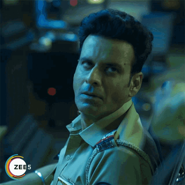 a man in a police uniform with the word zee5 on the bottom