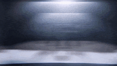 a dark room with a light shining on a table