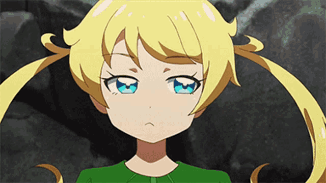 a little girl with blonde hair and blue eyes is wearing a green top