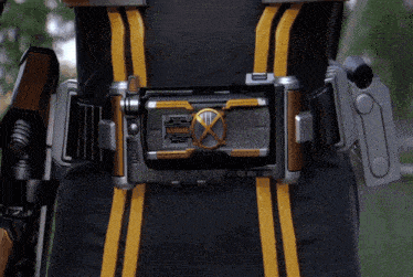 a person wearing a black and yellow belt with a x on it