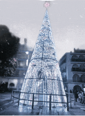 a large white christmas tree with a pink star on top