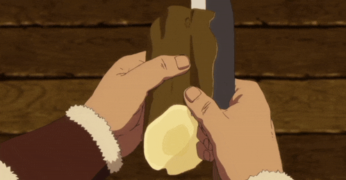 a person is holding a piece of wood with a knife