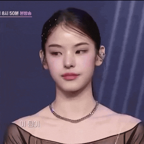 a close up of a woman wearing a necklace and earrings with korean writing on the bottom