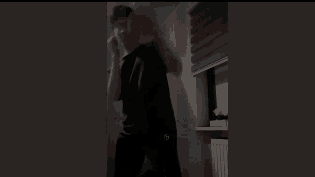 a dark room with a window and a box of tissues on the shelf