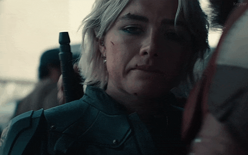 a close up of a woman holding a gun with the word kepler on the bottom right