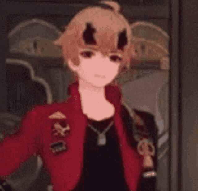 a boy with horns on his head is wearing a red jacket and a black shirt .